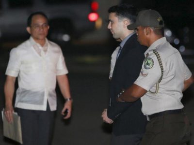 Philippine Bureau of Corrections personnel escort U.S. Marine Lance Corporal Joseph Scott Pemberton (C), after he was found guilty by trial court of killing Jennifer Laude, a transgender woman, upon arrival in a detention facility at Camp Aguinaldo in Quezon city, Metro Manila. PHOTO: REUTERS