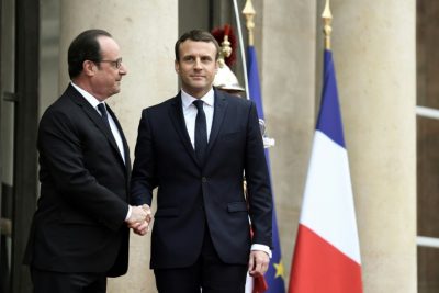 France's newly elected president Emmanuel Macron (R) is welcomed by his predecessor Francois Hollande as he arrives at the Elysee presidential palace in Paris for the handover and inauguration ceremonies on May 14, 2017