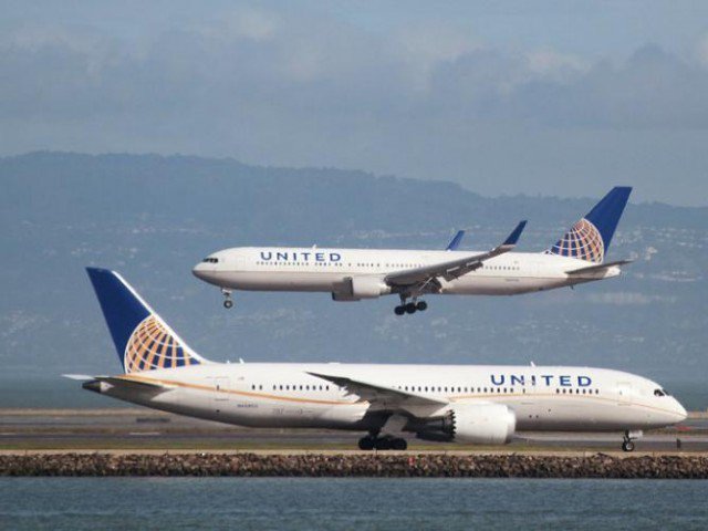 A United Airlines aircraft taxis as another lands at San Francisco International Airport, San Francisco, California. PHOTO: REUTERS