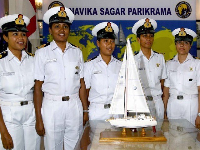 This handout photo taken on August 17, 2017 and released on September 5 by the Indian Navy shows Indian women naval officers posing for a picture in front of a model of a yacht in New Delhi, promoting their upcoming effort to sail around the world. Six Indian women naval officers are looking to shatter the glass ceiling as they set sail for an historic mission around the world PHOTO: AFP