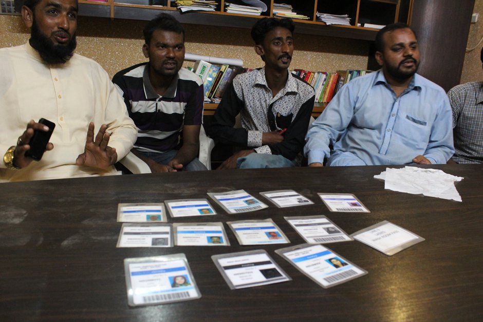 The sacked workers with their cards, cut by half, sharing their experiences at the sweatshop of H&M manufacturing