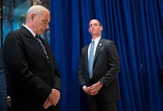 White House Chief of Staff John Kelly, left, looks at the floor at Trump Tower in New York on Aug. 15 as President Donald Trump addresses a violent confrontation over Confederate memorials in Charlottesville, Virginia