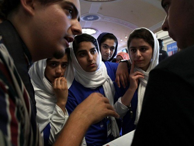 Somayeh Faruqi, Lida Azizi, Yasimin Yasinzadah, and Kawsar Roshan of Team Afghanistan listen, through embassy staff Mojib Ghaznawi’s (L) translation, as they discuss strategy with a member of Team North America. PHOTO: AFP